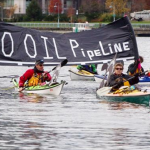Kayakers display a “No Oil Pipeline” banner during a protest against the Enbridge Northern Gateway pipeline in Vancouver, in this Nov. 16, 2013 file photo. Photograph by: DARRYL DYCK, THE CANADIAN PRESS/file